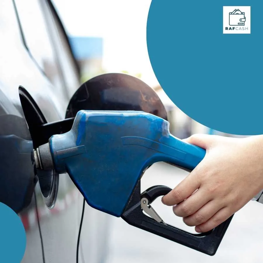 Close-up of a hand holding a blue fuel pump nozzle while refueling a car, representing the fuel levy aspect of the Road Accident Fund.