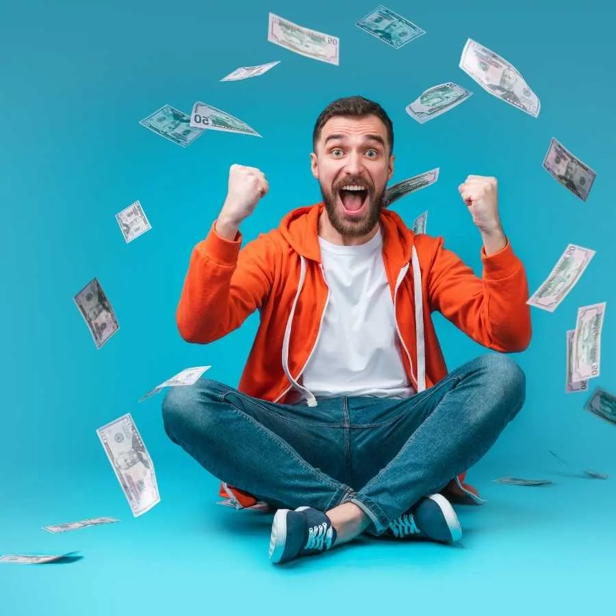Excited man celebrating with falling money