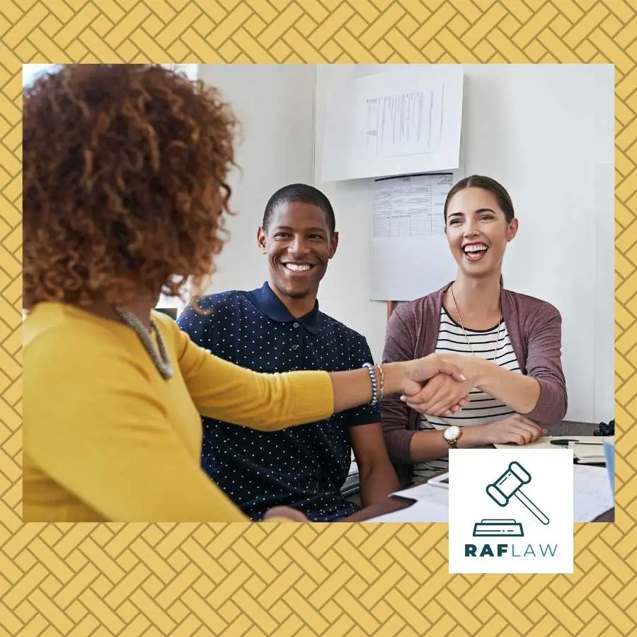 Attorney shaking hands with clients, symbolizing a successful agreement with the RAF LAW logo in the foreground.