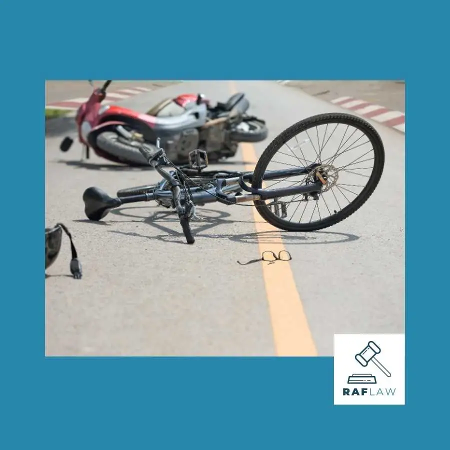 A bicycle and motorbike after a collision, depicting a potential road incident leading to leg injuries and RAF Law claims.