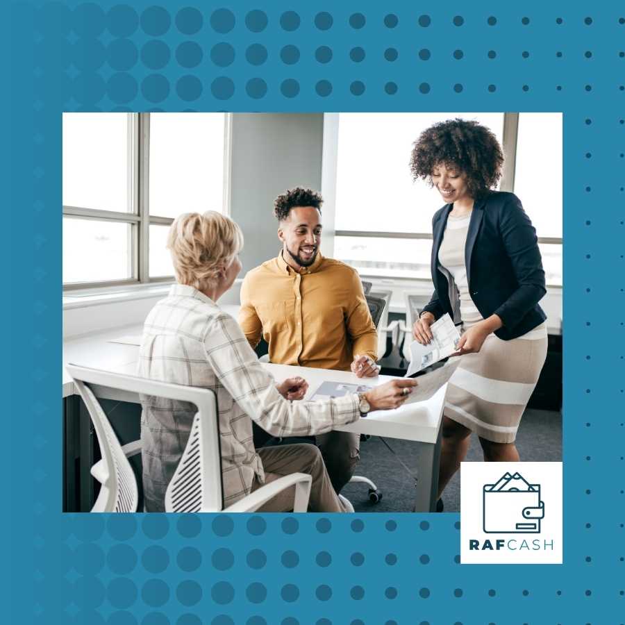 Legal consultant discussing documents with clients in a bright office setting.