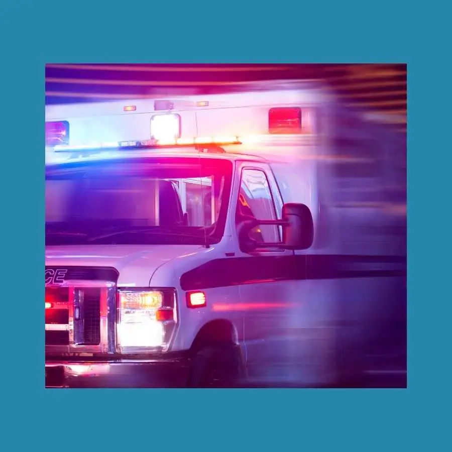 Blurry motion of a fast-moving ambulance with emergency lights on