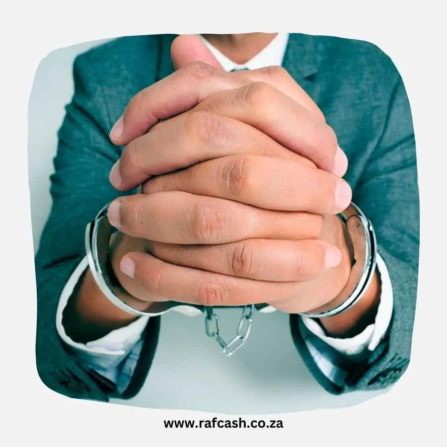 Close-up of handcuffed hands in a business suit, symbolizing the legal consequences of embezzlement.