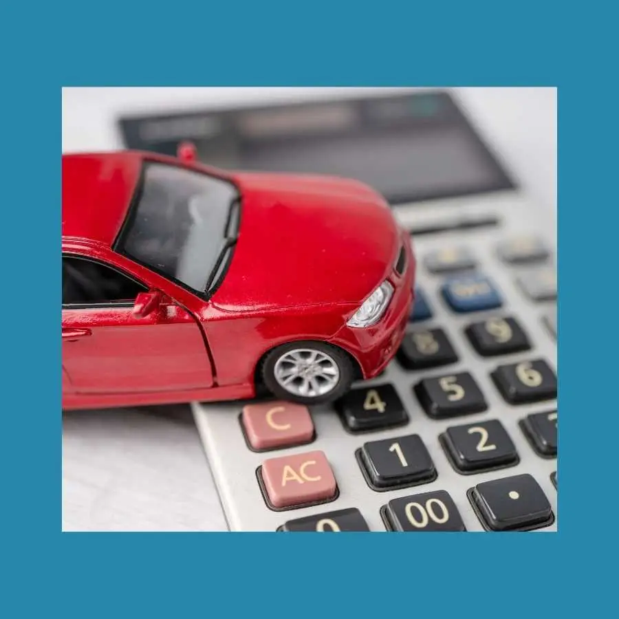 Red Toy Car on Calculator Concept for Motor Insurance Costs