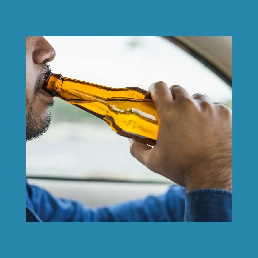 Close-Up of a Driver Drinking Alcohol While Driving
