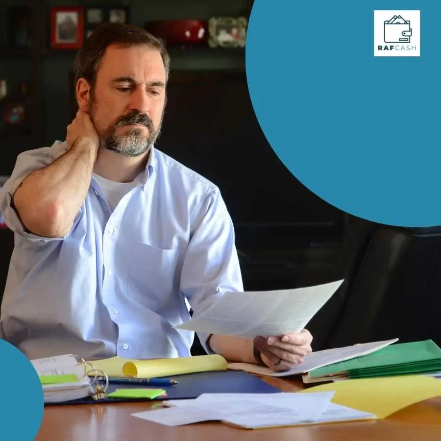 Man in a blue shirt reviewing documents, symbolizing claim evaluation for RAF