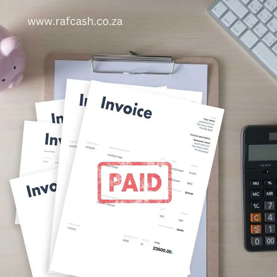 Stack of paid invoices on a desk with a calculator, clipboard, and keyboard