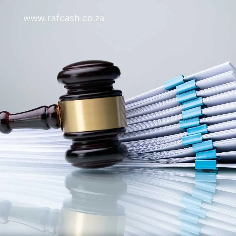 Gavel resting on a stack of legal documents with blue clips