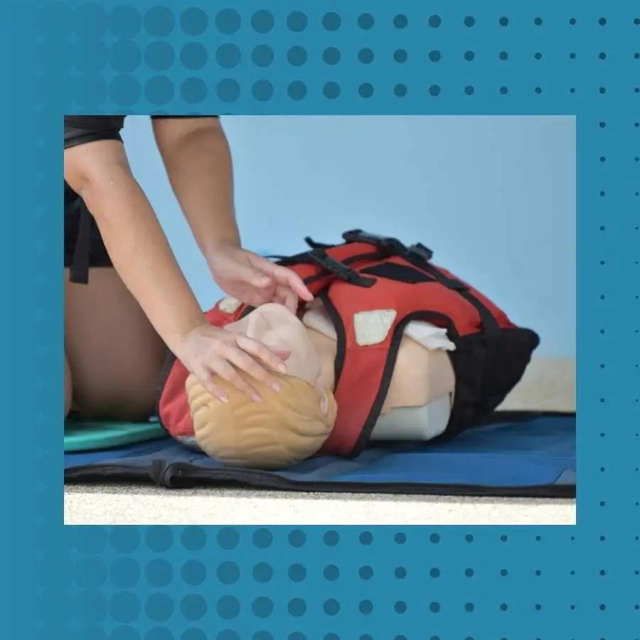 CPR training on a dummy by a woman demonstrating emergency procedures