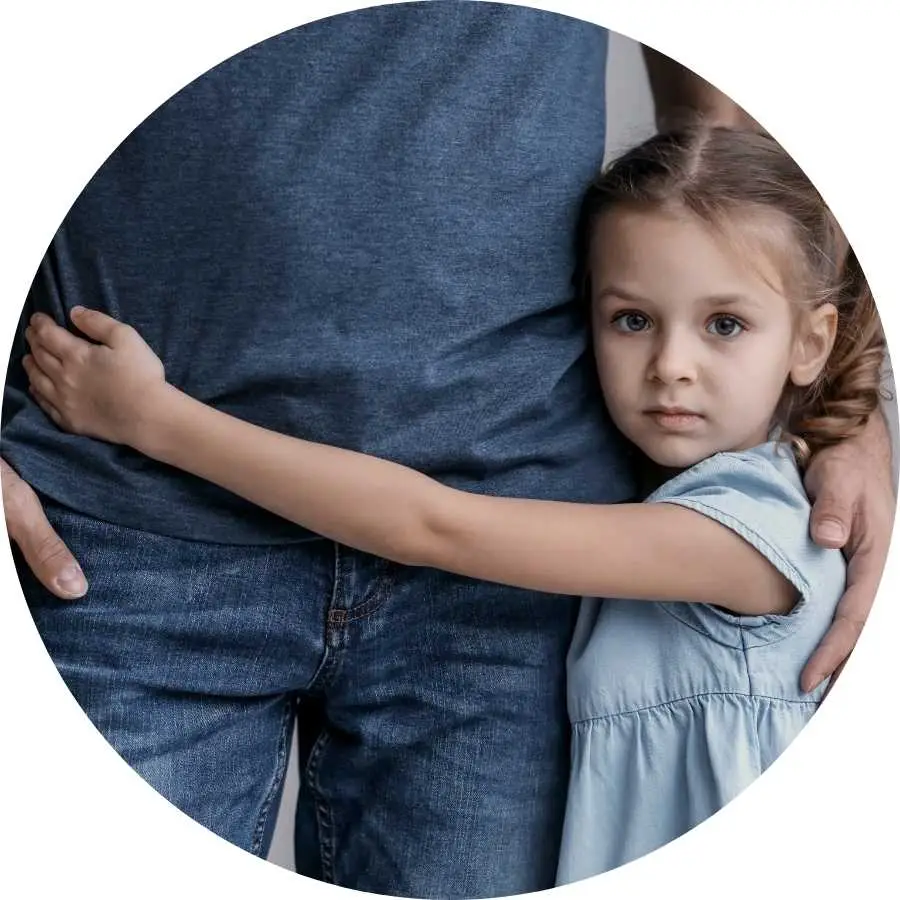 Young girl hugging her father tightly