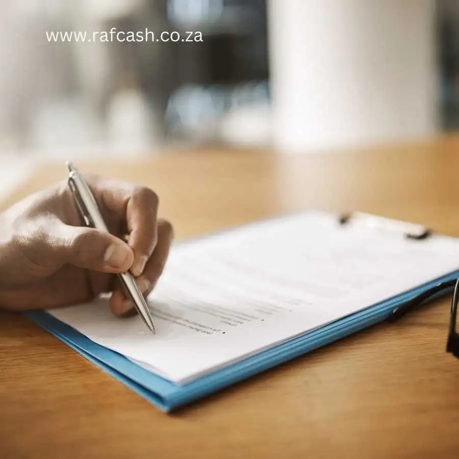 Close-up of a person writing on a form with a pen