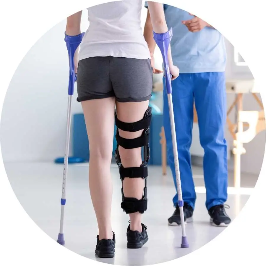 Woman using crutches and a knee brace as she rehabilitates from an injury