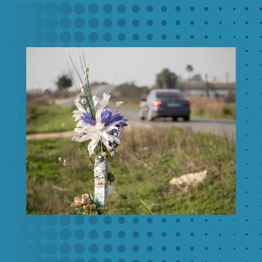 Memorial flowers tied to a roadside pole in South Africa