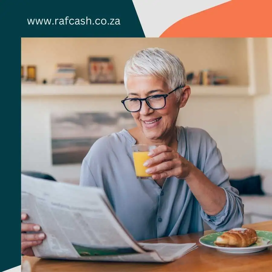 Older woman reading newspaper and drinking orange juice