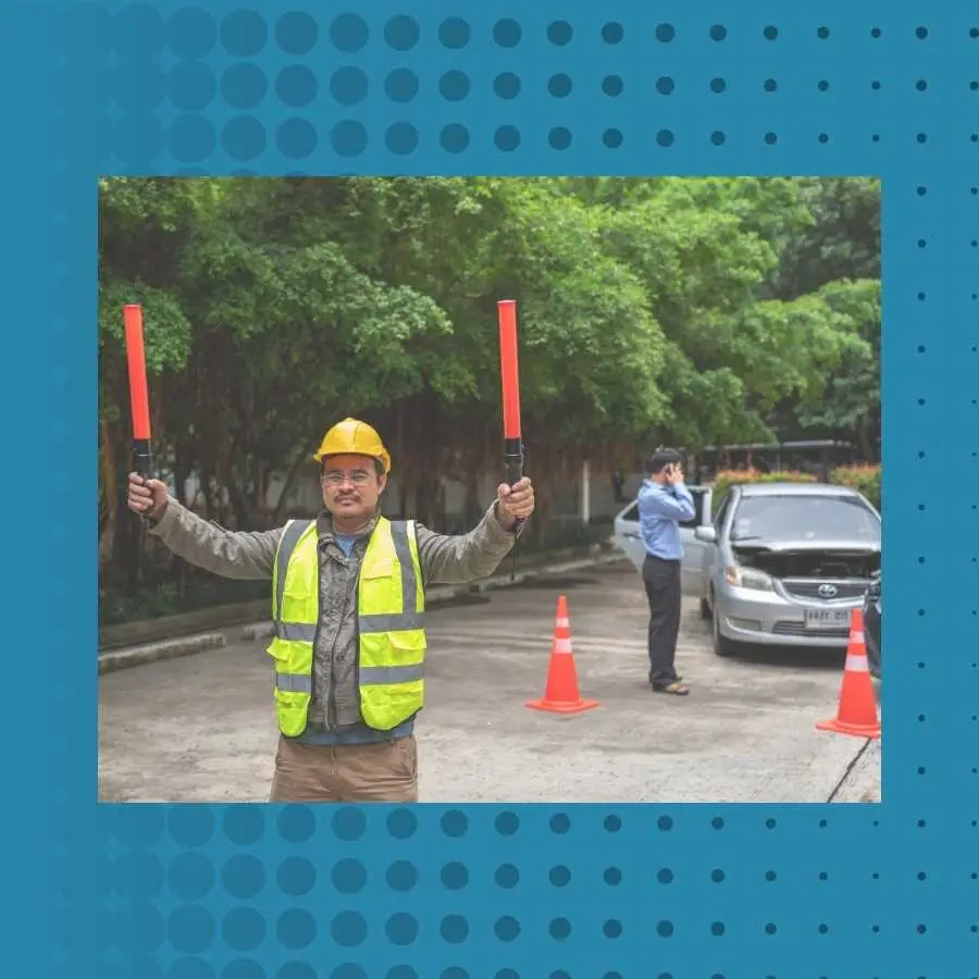 Traffic controller directing vehicles with red batons