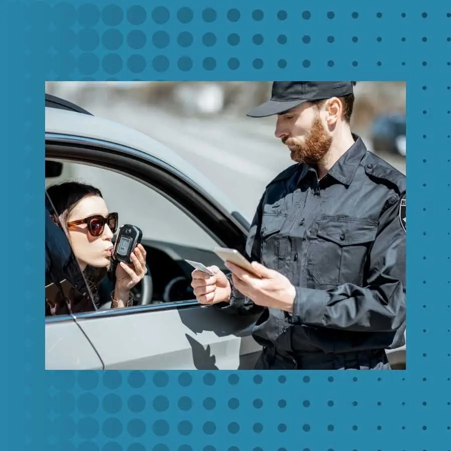 Police officer conducting a breathalyzer test on a female driver