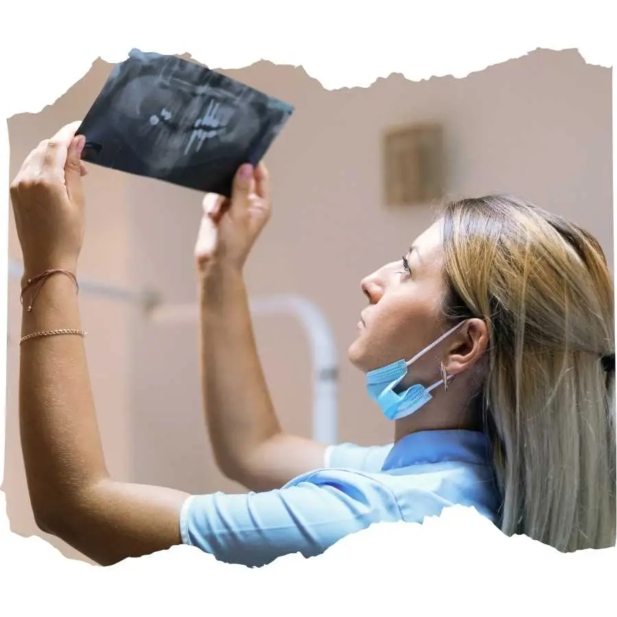 Female healthcare professional examining an X-ray film