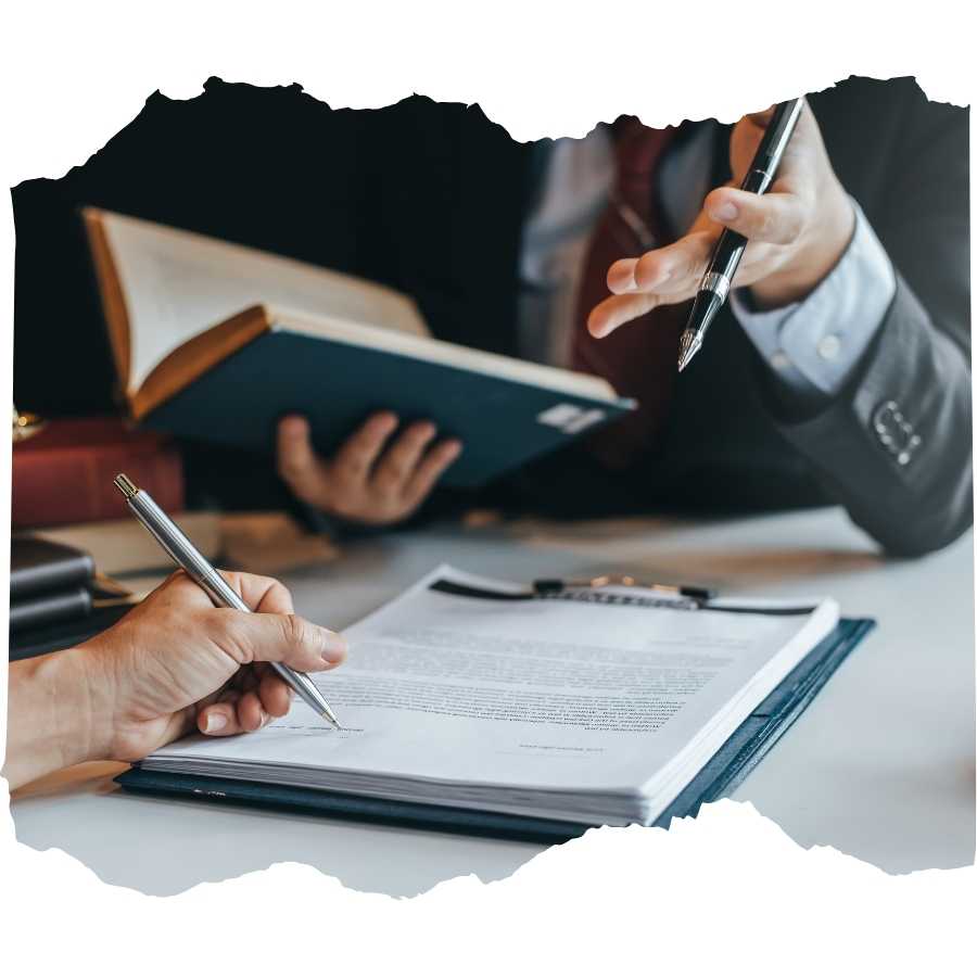 Lawyers discussing legal documents with a book and pen in hand