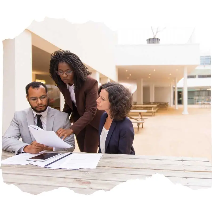 Legal team discussing documents outdoors