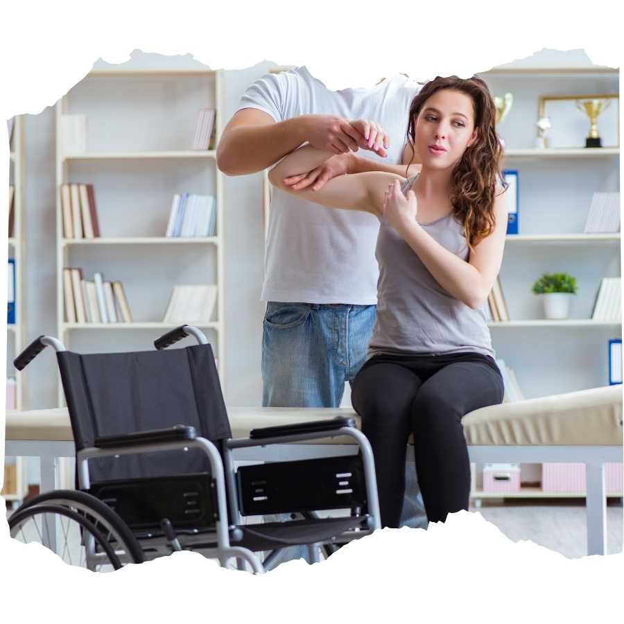 Physical therapist assisting a woman with arm exercises next to a wheelchair