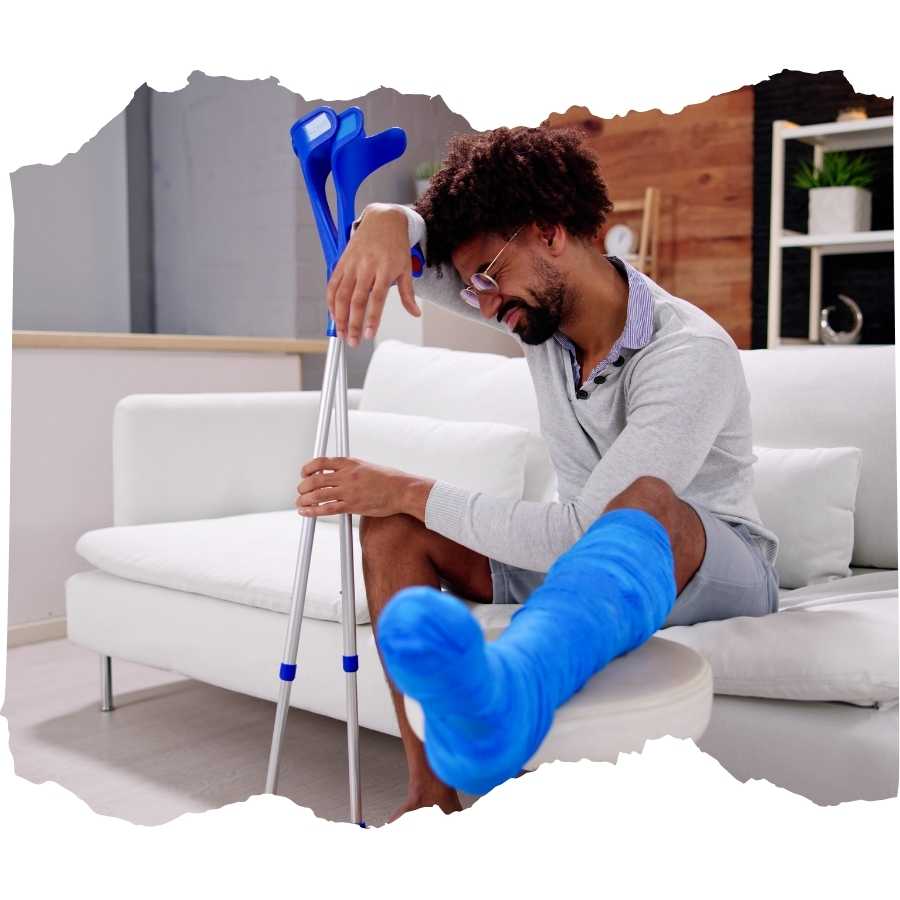 Man with a cast on his leg using crutches to stand up from a couch