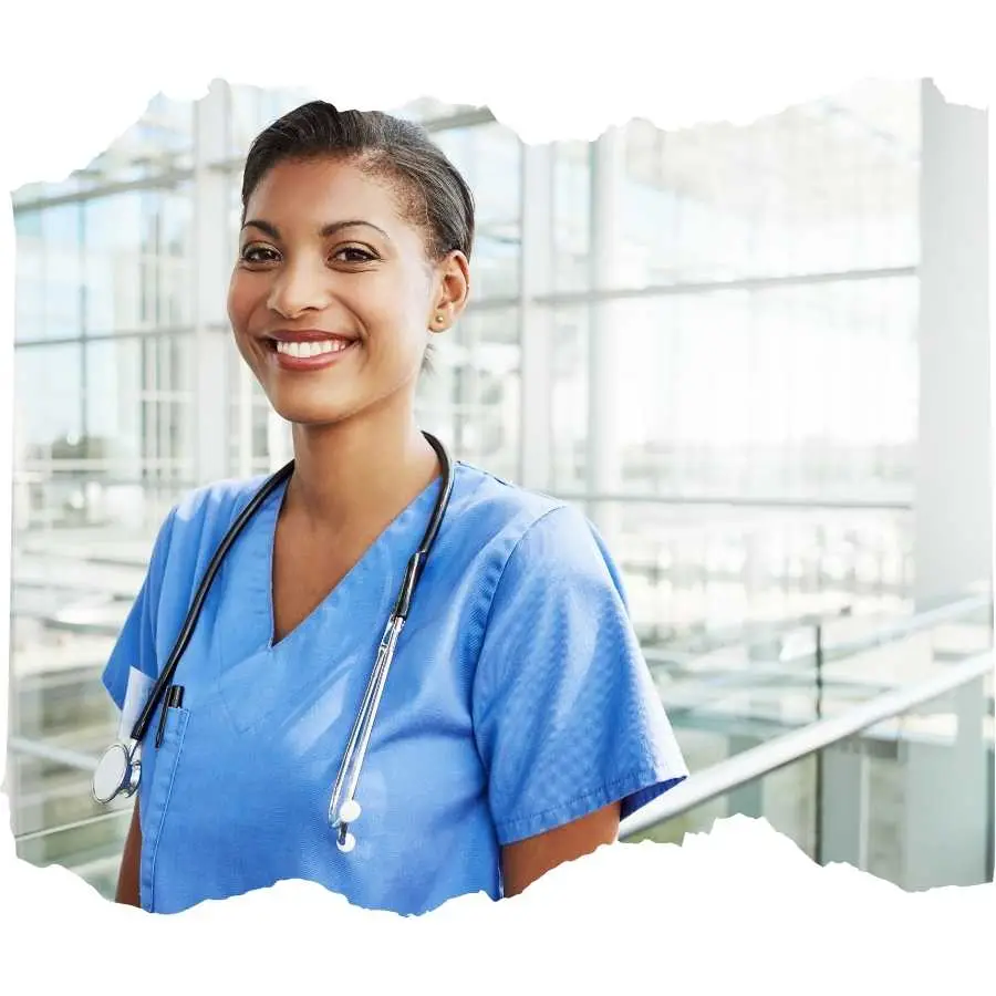 Smiling nurse with a stethoscope standing in a bright hospital corridor