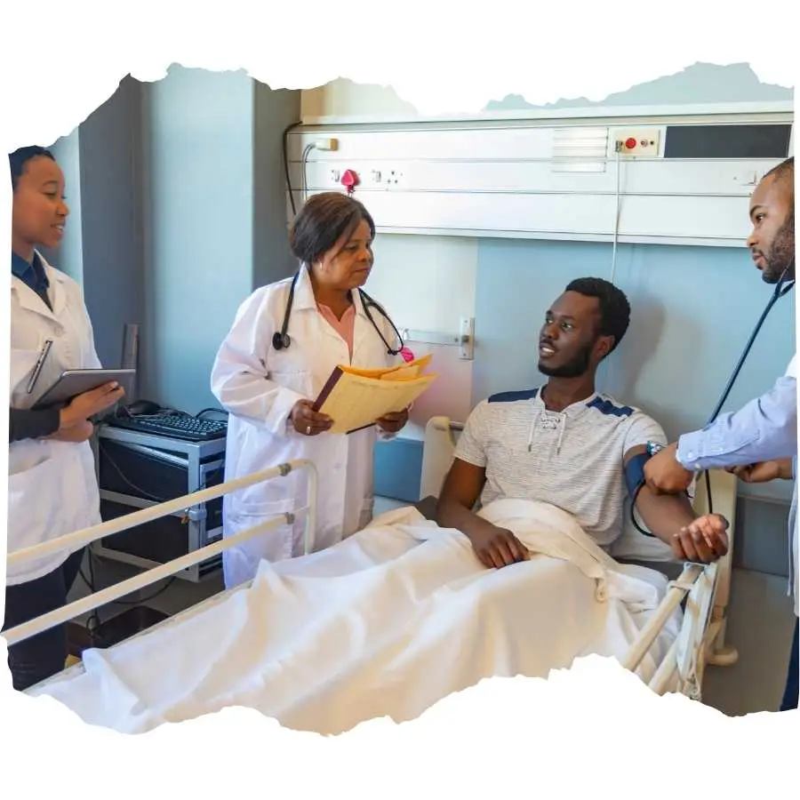 Medical team consulting with a patient in a hospital bed