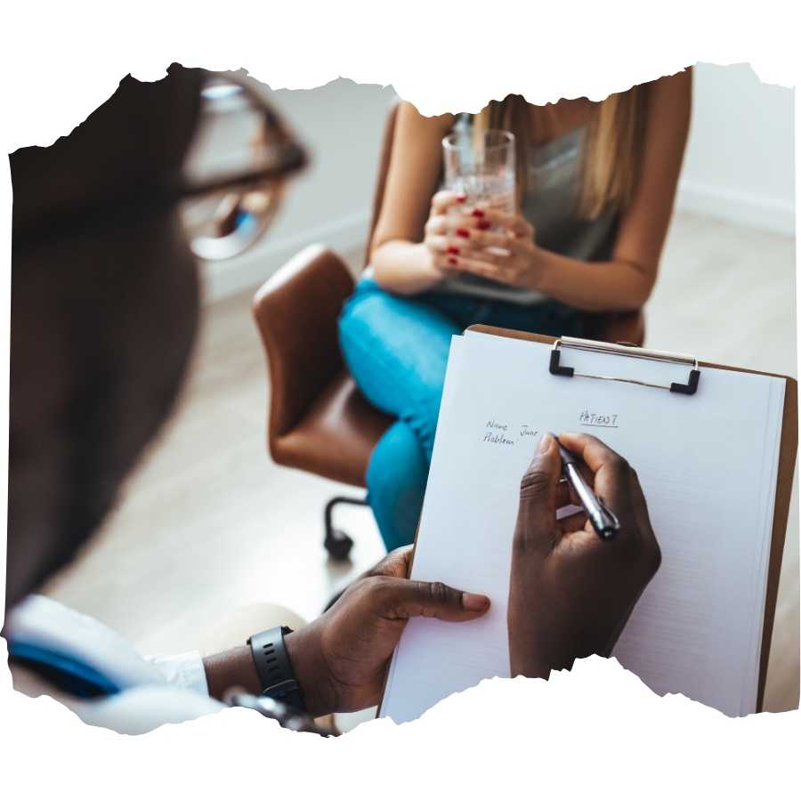 Therapist taking notes during a session with a motor accident survivor