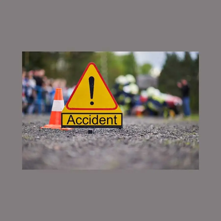 Road accident scene with emergency services and warning sign