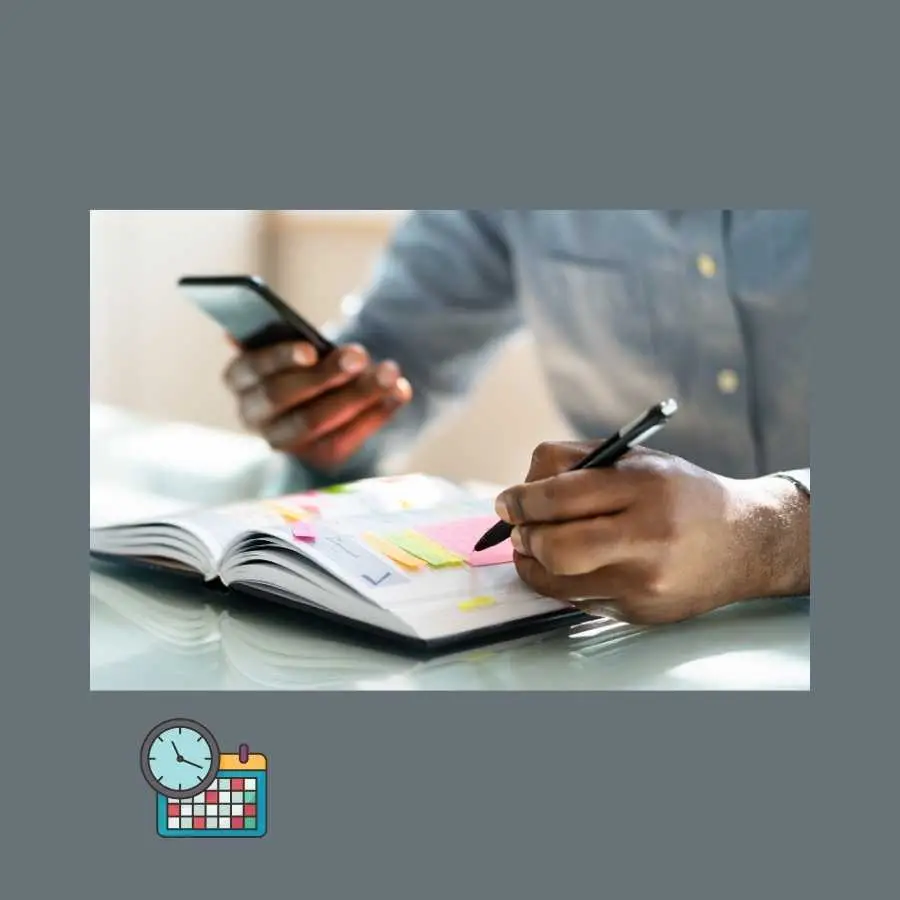 Close-up of a person's hands writing notes and using a smartphone for scheduling