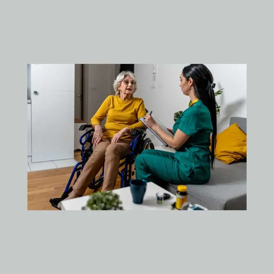 Nurse discussing treatment with elderly woman in wheelchair