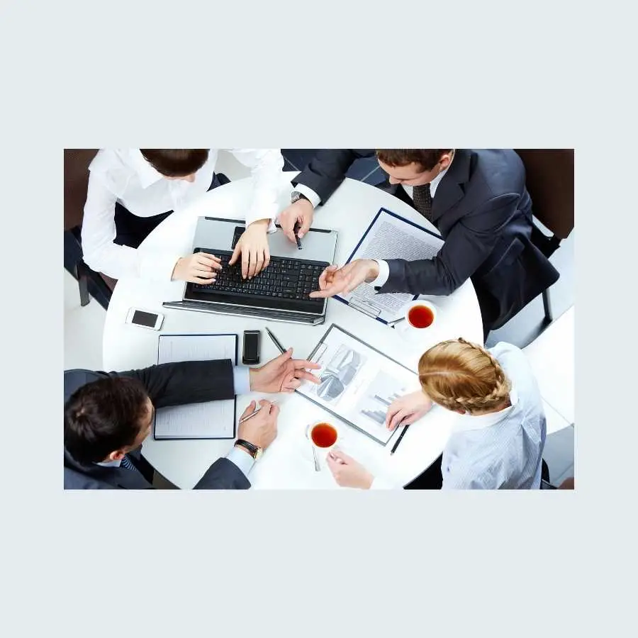 Business professionals discussing strategies around a conference table