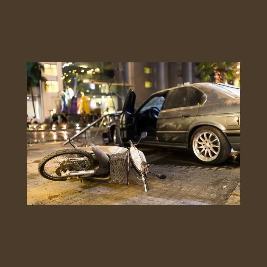 Damaged motorcycle and car after an accident on a city street