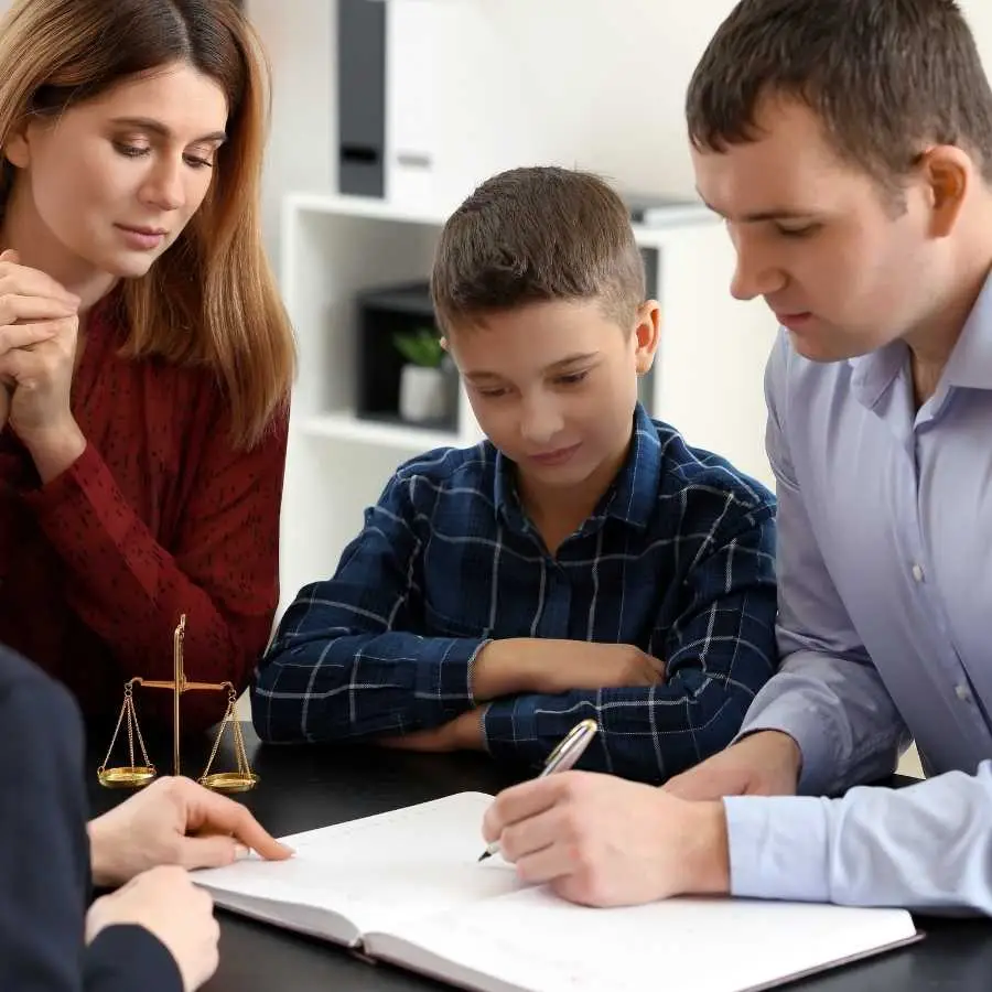 Family discussing legal documents with an attorney in an office setting