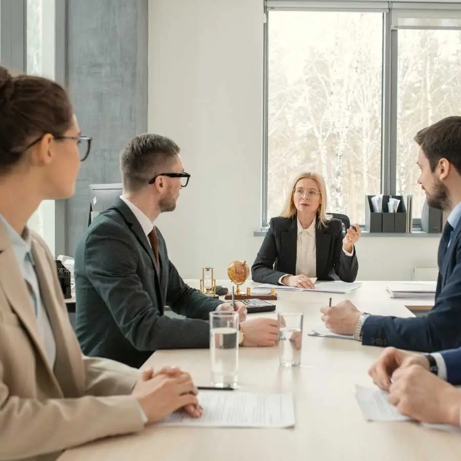 Business meeting with four legal professionals discussing at a conference table