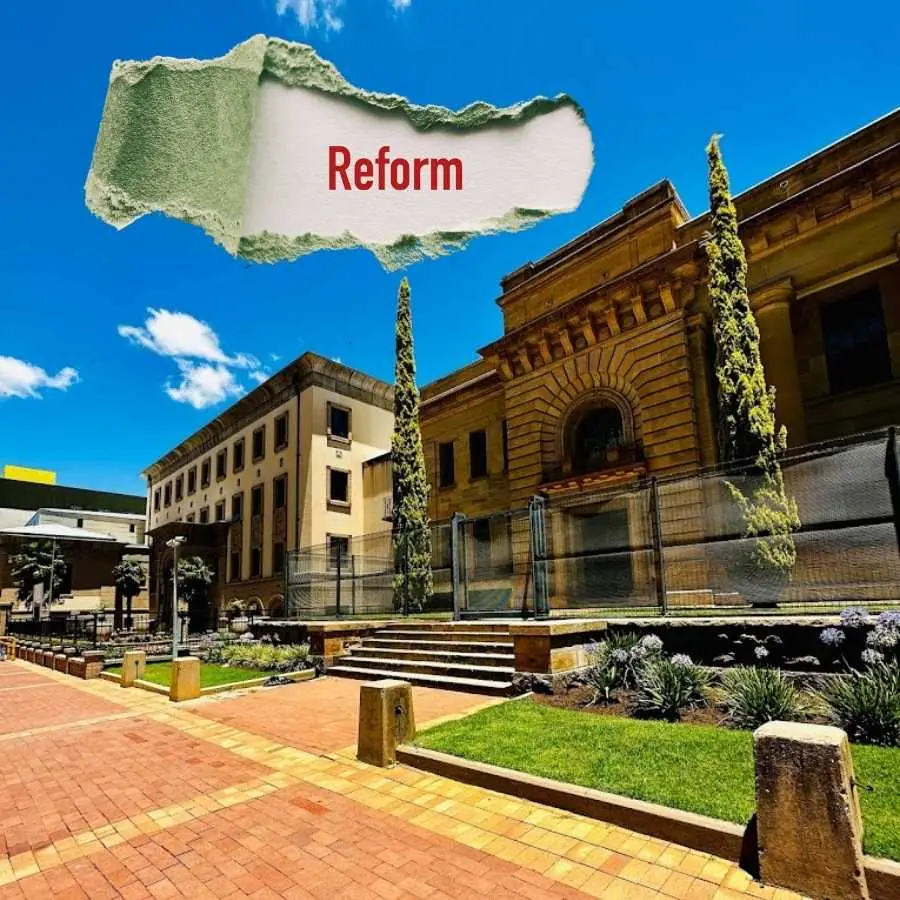 Exterior of Bloemfontein High Court with the word "Reform" above