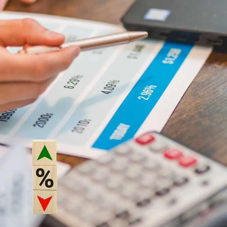 Hand pointing at interest rate chart with a pen