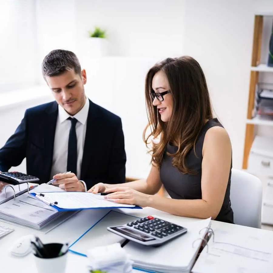 Financial advisor discussing documents with client in office