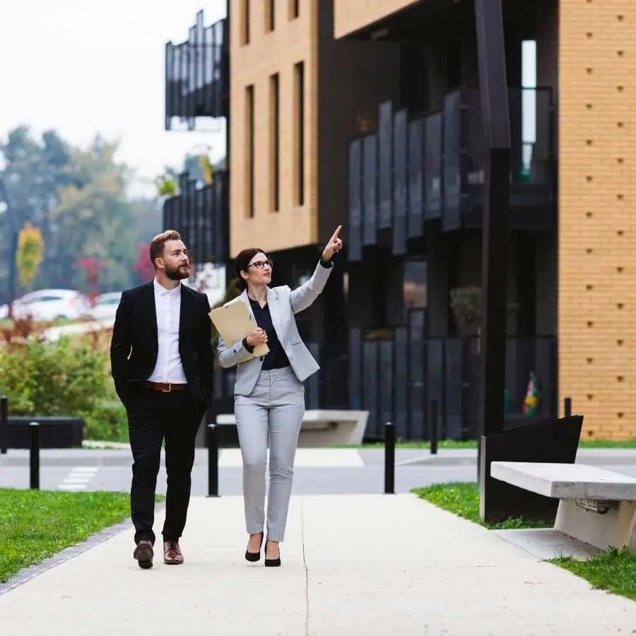 Business professionals discussing property development and investment options outdoors