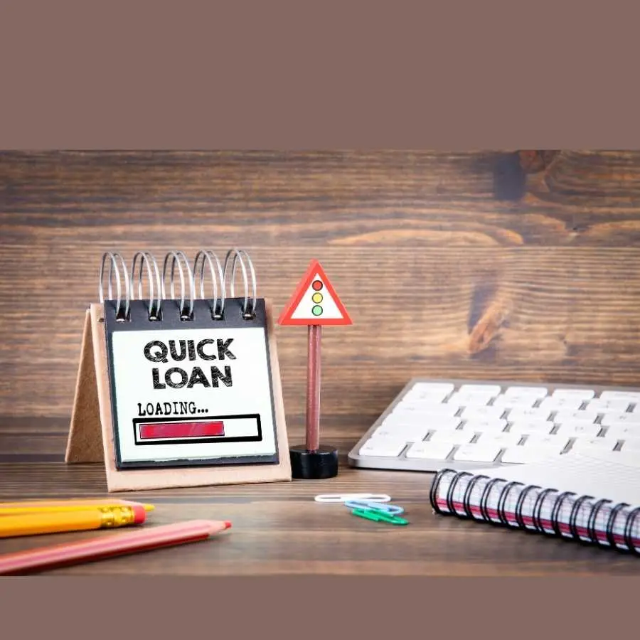 Quick loan loading sign on a desk with office supplies