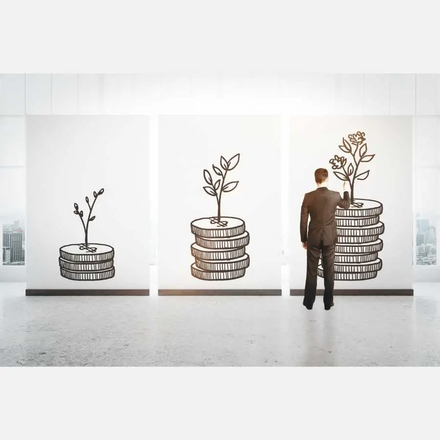 Businessman drawing growth stages of plant on coin stacks